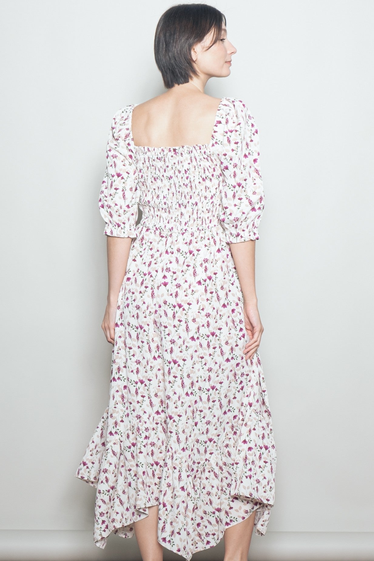 woman wearing a white floral midi dress with puff sleeves and a smocked back detail