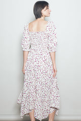 woman wearing a white floral midi dress with puff sleeves and a smocked back detail