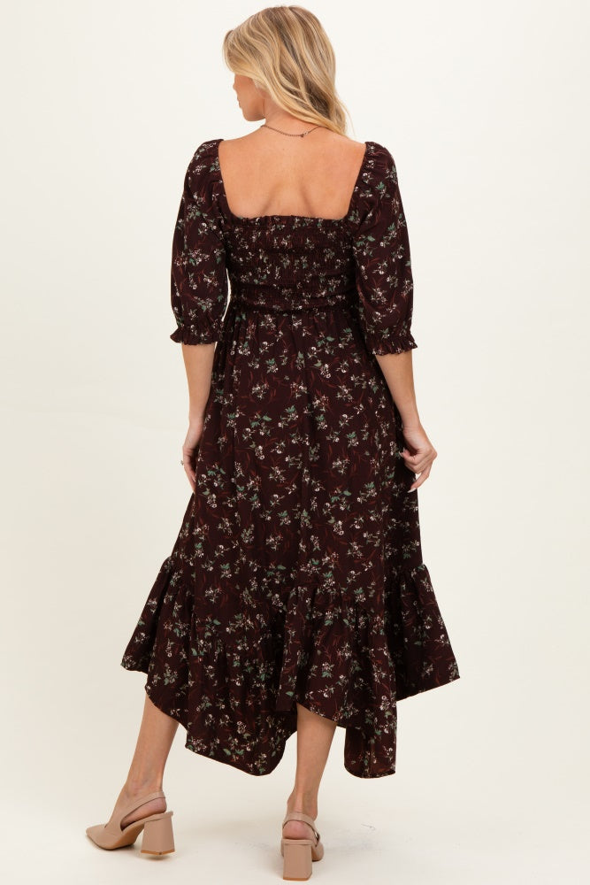 woman wearing a burgundy floral maternity dress with a square neckline and three-quarter sleeves, showing a baby bump from the back