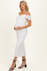 woman wearing a white off-the-shoulder maternity dress with a fitted silhouette and a visible baby bump