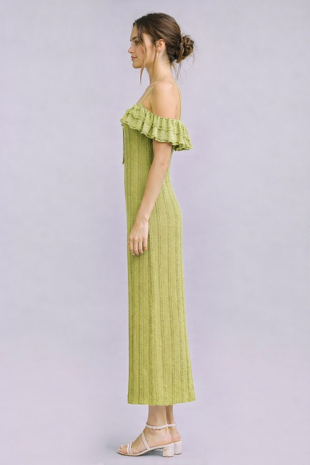 woman wearing a light green off-the-shoulder ribbed maxi dress with ruffle details and strappy sandals