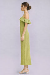woman wearing a light green off-the-shoulder ribbed maxi dress with ruffle details and strappy sandals