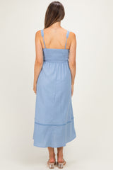 woman wearing a light blue maternity maxi dress with a smocked back and adjustable straps