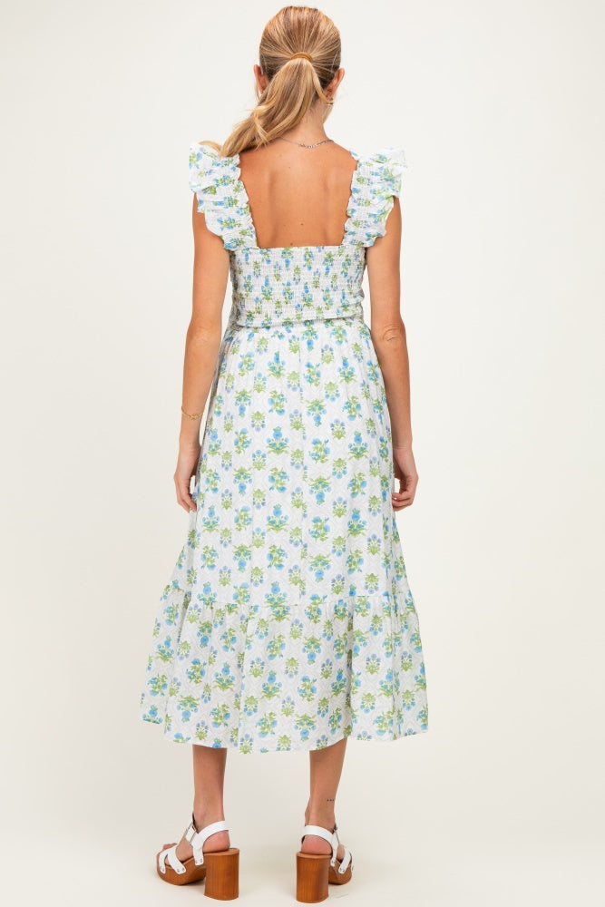 woman wearing a floral print maternity dress with ruffled straps and a smocked back, shown from the back