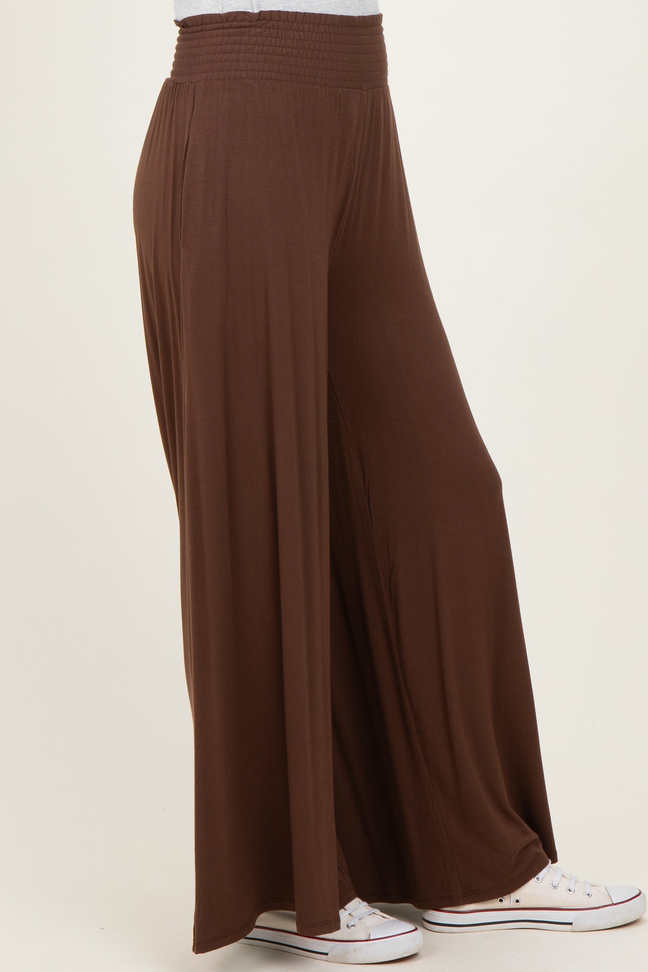 woman wearing brown wide-leg pants with a smocked waistband