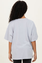woman wearing a light gray oversized t-shirt seen from the back
