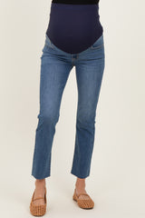 woman wearing a pair of blue denim maternity jeans with a stretchy navy waistband and light brown sandals