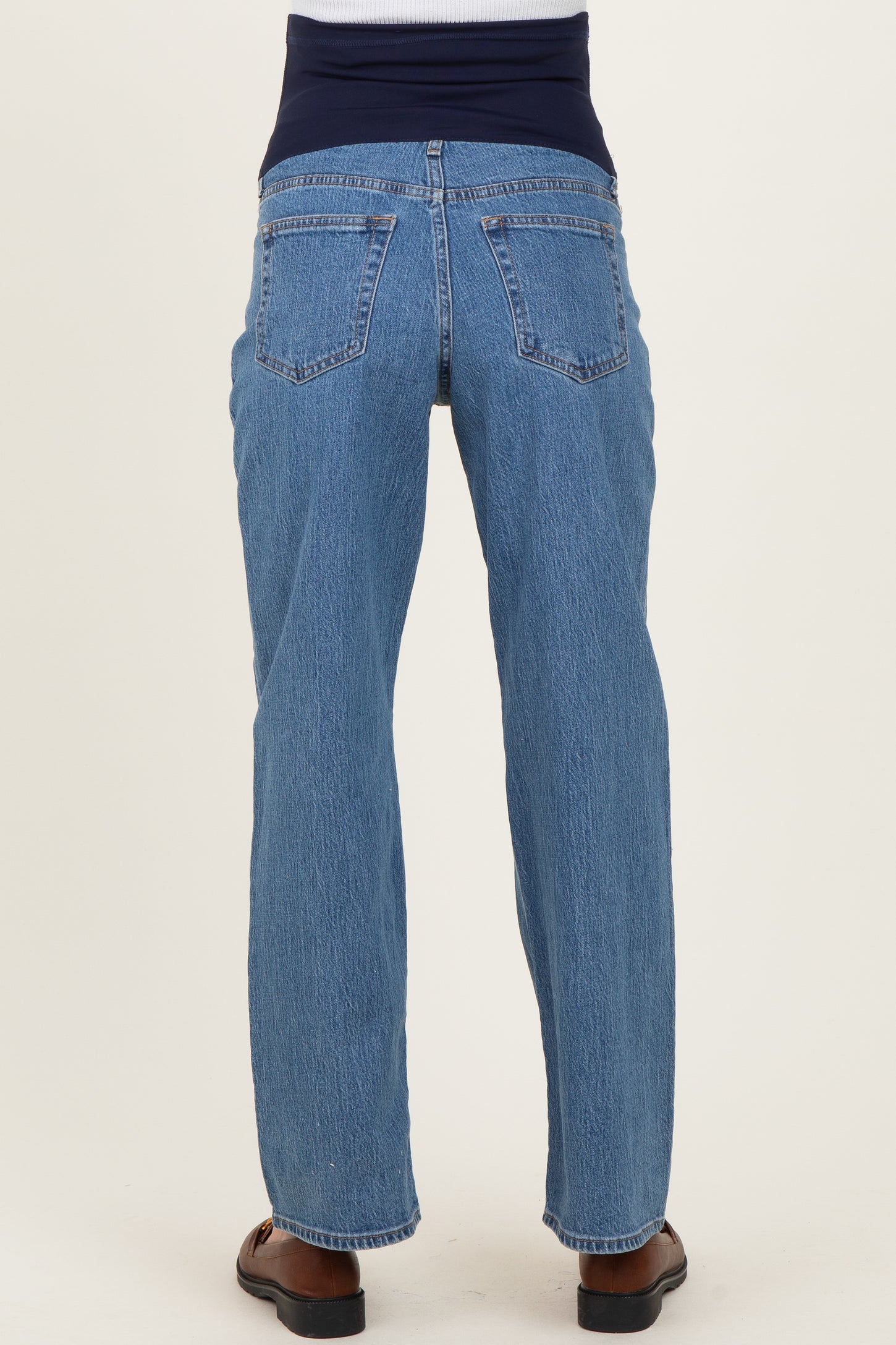 maternity wear blue straight leg jeans with a stretchy dark blue waistband, shown from the back