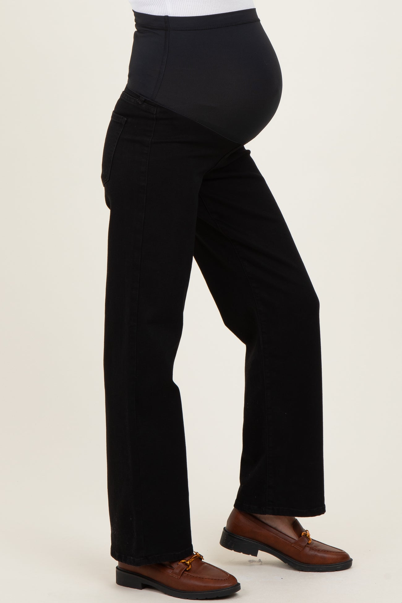 woman wearing black maternity jeans with a high, supportive waistband and visible baby bump