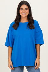 woman wearing a bright blue oversized t-shirt with wide sleeves and a relaxed fit