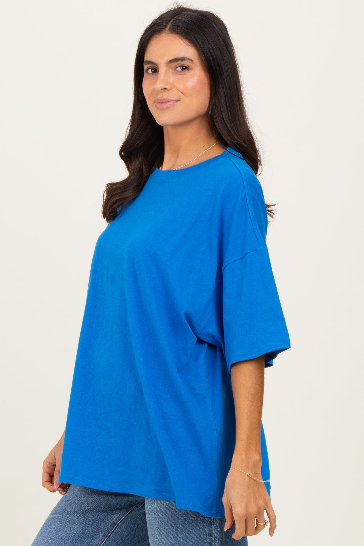woman wearing a bright blue oversized t-shirt with short sleeves and a relaxed fit