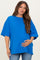 woman wearing a bright blue oversized maternity t-shirt and holding her baby bump