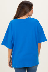 woman wearing a bright blue oversized maternity t-shirt from the back, styled with casual jeans