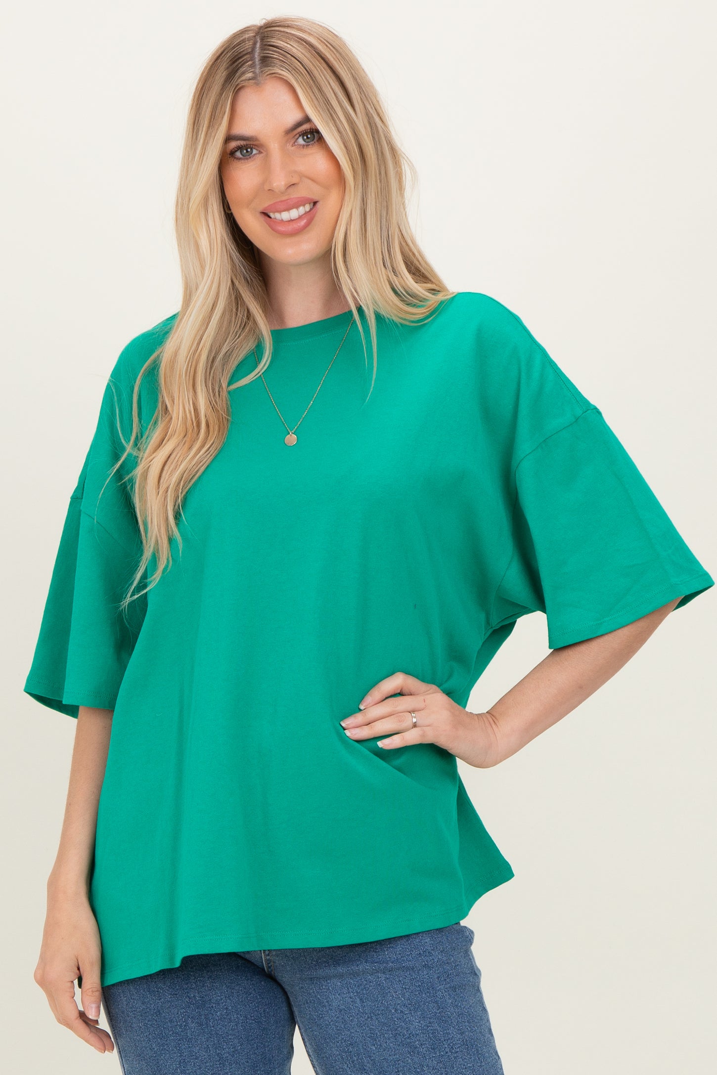 woman wearing a bright green oversized t-shirt with short sleeves and relaxed fit