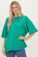 woman wearing a bright green oversized t-shirt with short sleeves and relaxed fit