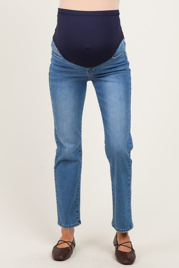 woman wearing a pair of blue maternity jeans with a navy over-the-bump waistband