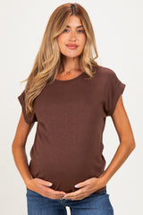 woman wearing a brown short sleeve maternity top and holding her baby bump