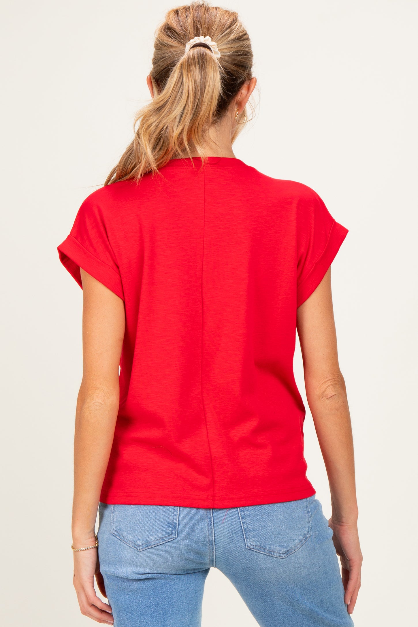 woman wearing a red short sleeve maternity t-shirt with a relaxed fit, seen from the back