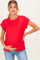 woman wearing a red short sleeve maternity top and holding her baby bump