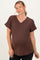 woman wearing a brown v-neck maternity top with rolled sleeves and a front pocket, showing a baby bump
