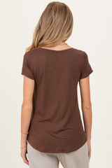 woman wearing a brown short sleeve maternity top, shown from the back
