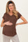 woman wearing a brown maternity top with a v-neck and holding her baby bump