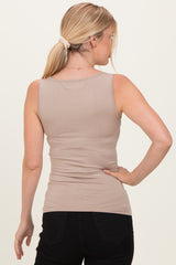 woman wearing a beige fitted tank top from the back with a ponytail hairstyle