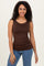 woman wearing a brown sleeveless fitted top paired with blue denim jeans