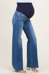 woman wearing blue wide-leg maternity jeans with a navy over-the-bump waistband and a visible baby bump