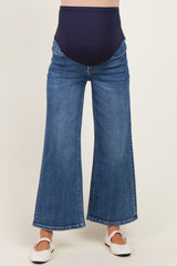 maternity wear blue wide leg jeans with a high waistband, model wearing white shoes