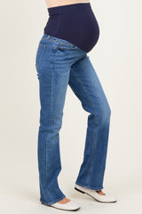 woman wearing dark blue maternity jeans with a supportive waistband and a visible baby bump