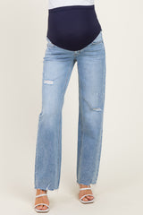 woman wearing light blue distressed maternity jeans with a dark blue over-the-bump waistband