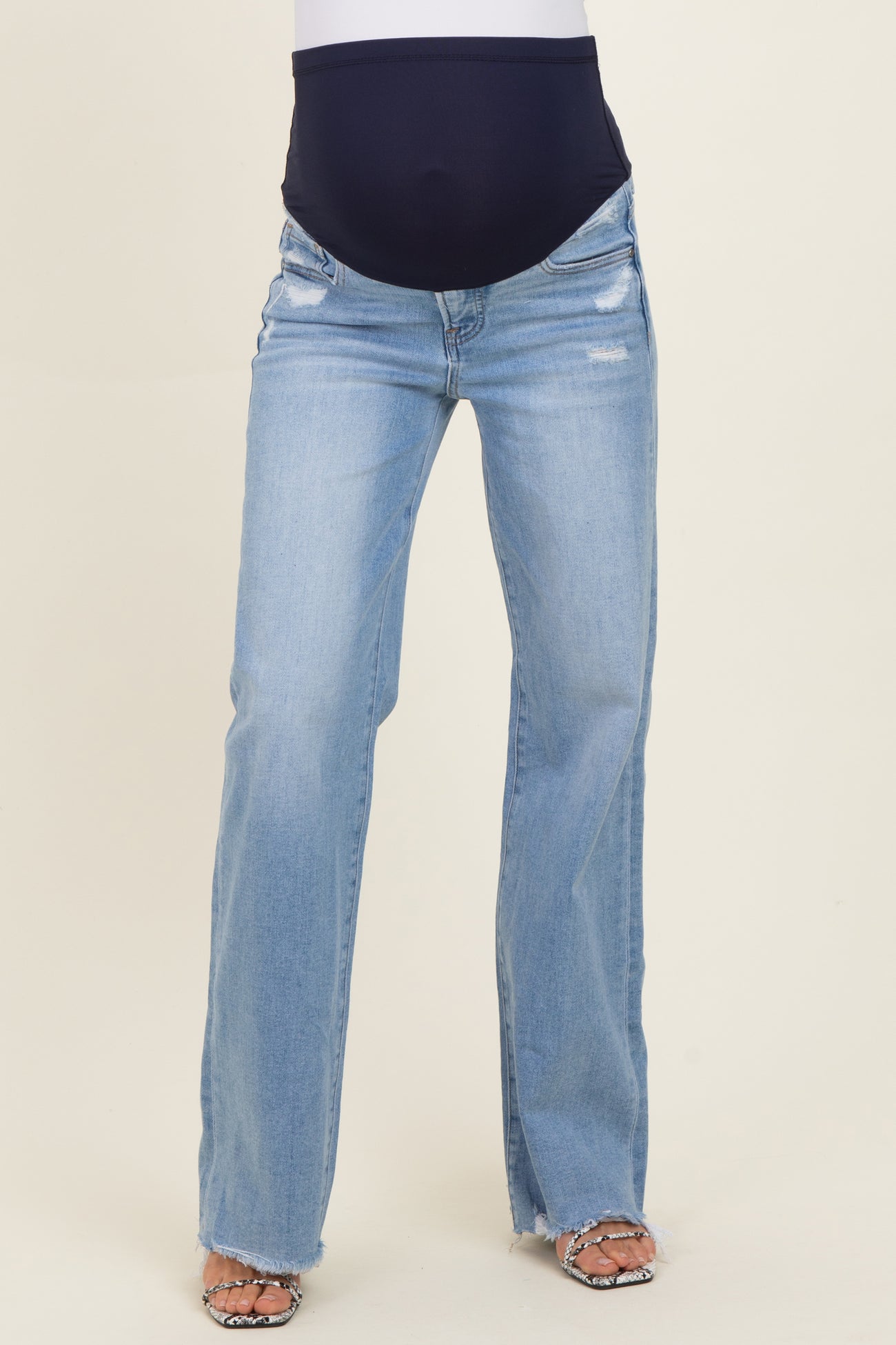 maternity wear light blue distressed straight leg jeans with a supportive belly panel