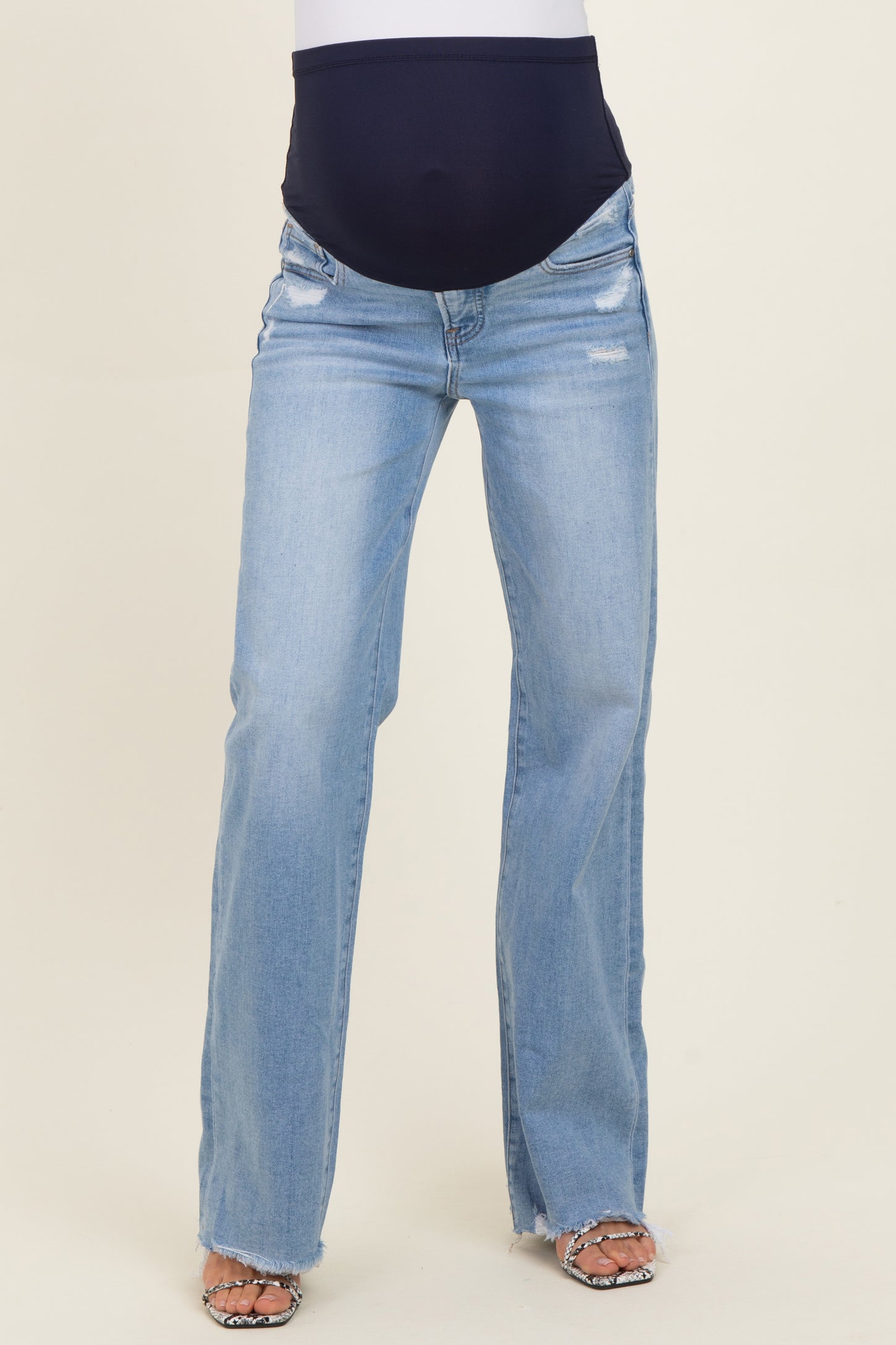 maternity wear light blue distressed straight leg jeans with a supportive belly panel