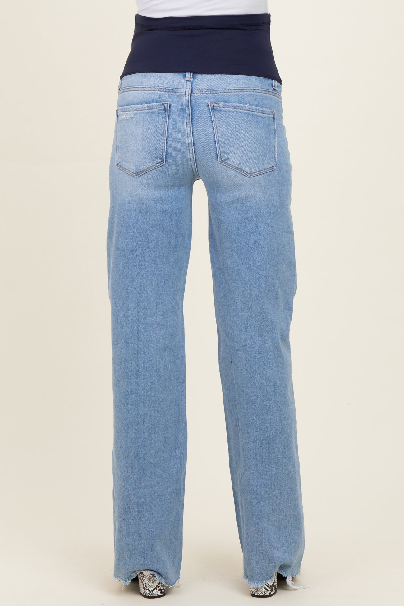 maternity wear blue straight-leg jeans with a stretchy navy waistband, shown from the back