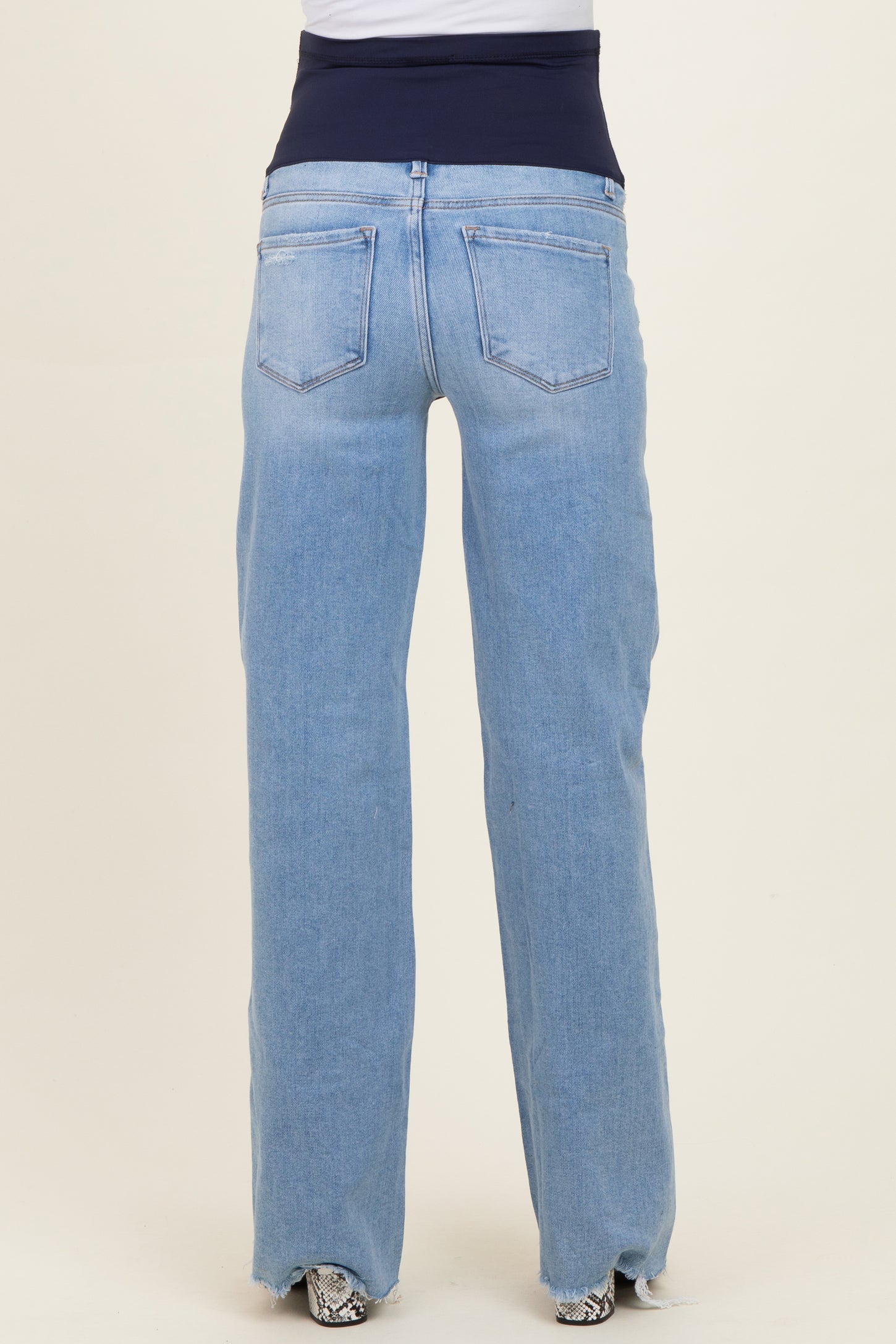 maternity wear blue straight-leg jeans with a stretchy navy waistband, shown from the back