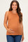 woman wearing a rust-colored sleeveless maternity top and holding her baby bump