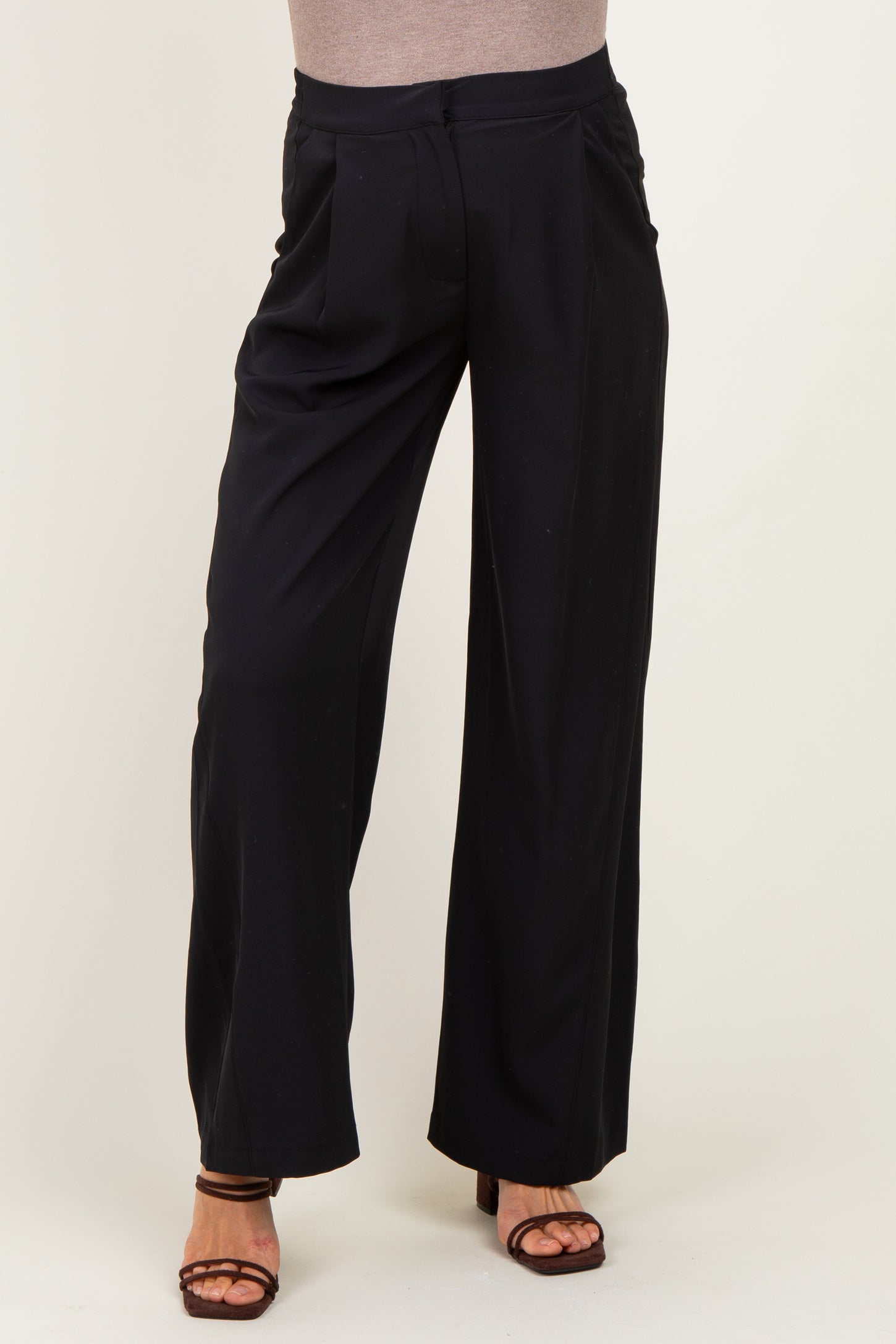 woman wearing black maternity wide-legged pants with a high waist and relaxed fit