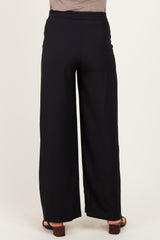 woman wearing black wide-leg maternity pants, shown from the back