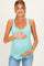woman wearing a light teal maternity tank top and holding her baby bump