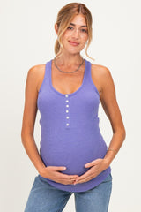 woman wearing a purple maternity tank top with buttons, holding her baby bump