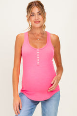 woman wearing a bright pink ribbed maternity tank top with button details and a visible baby bump