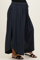 woman wearing a navy blue maternity maxi skirt with a high-low hem and elastic waistband