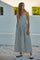 woman wearing a strapless black and white striped maxi dress with a gathered bodice and a flowing skirt