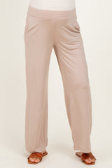 woman wearing beige maternity pants with a comfortable waistband and loose fit
