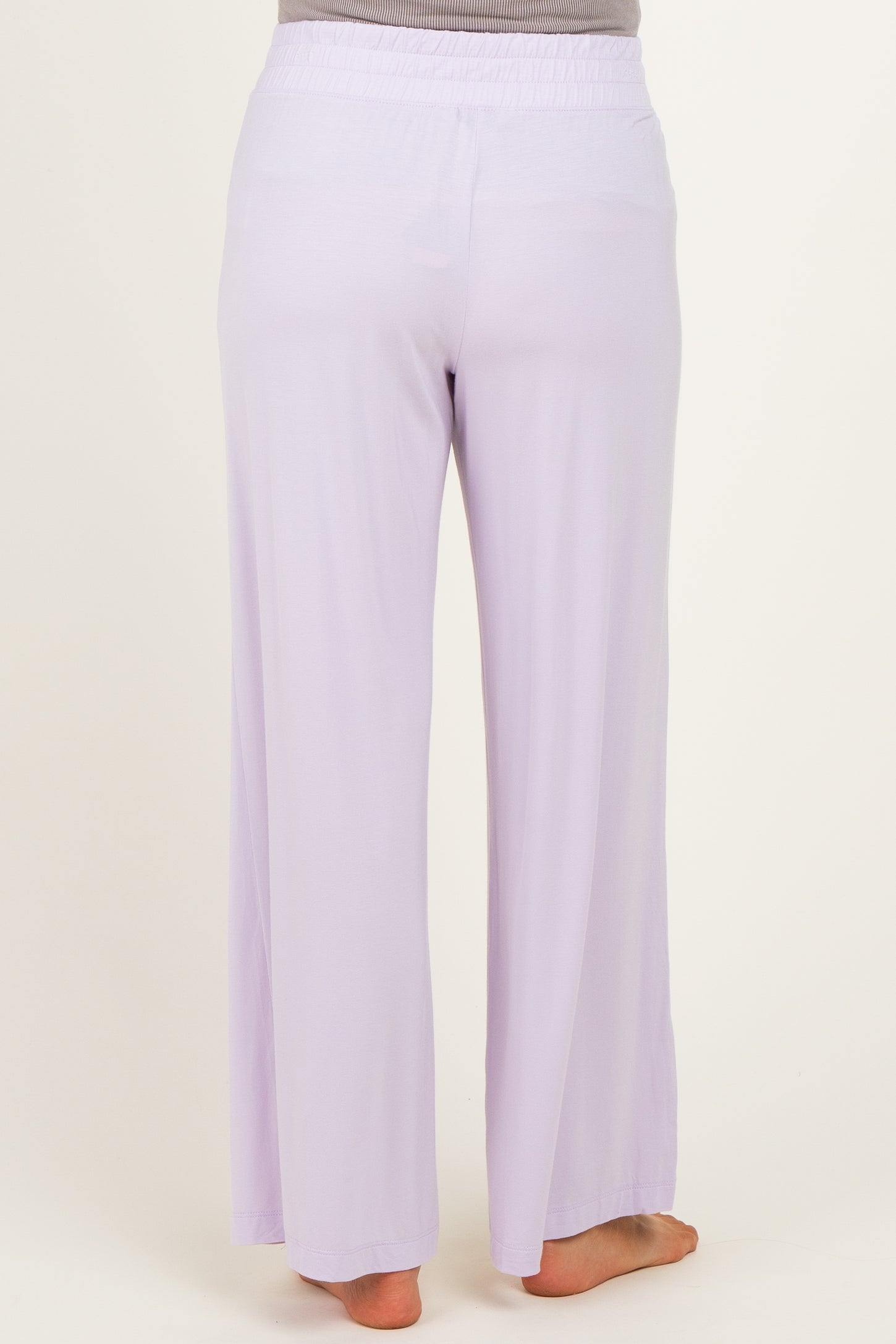 woman wearing light purple maternity wide-leg pants seen from the back