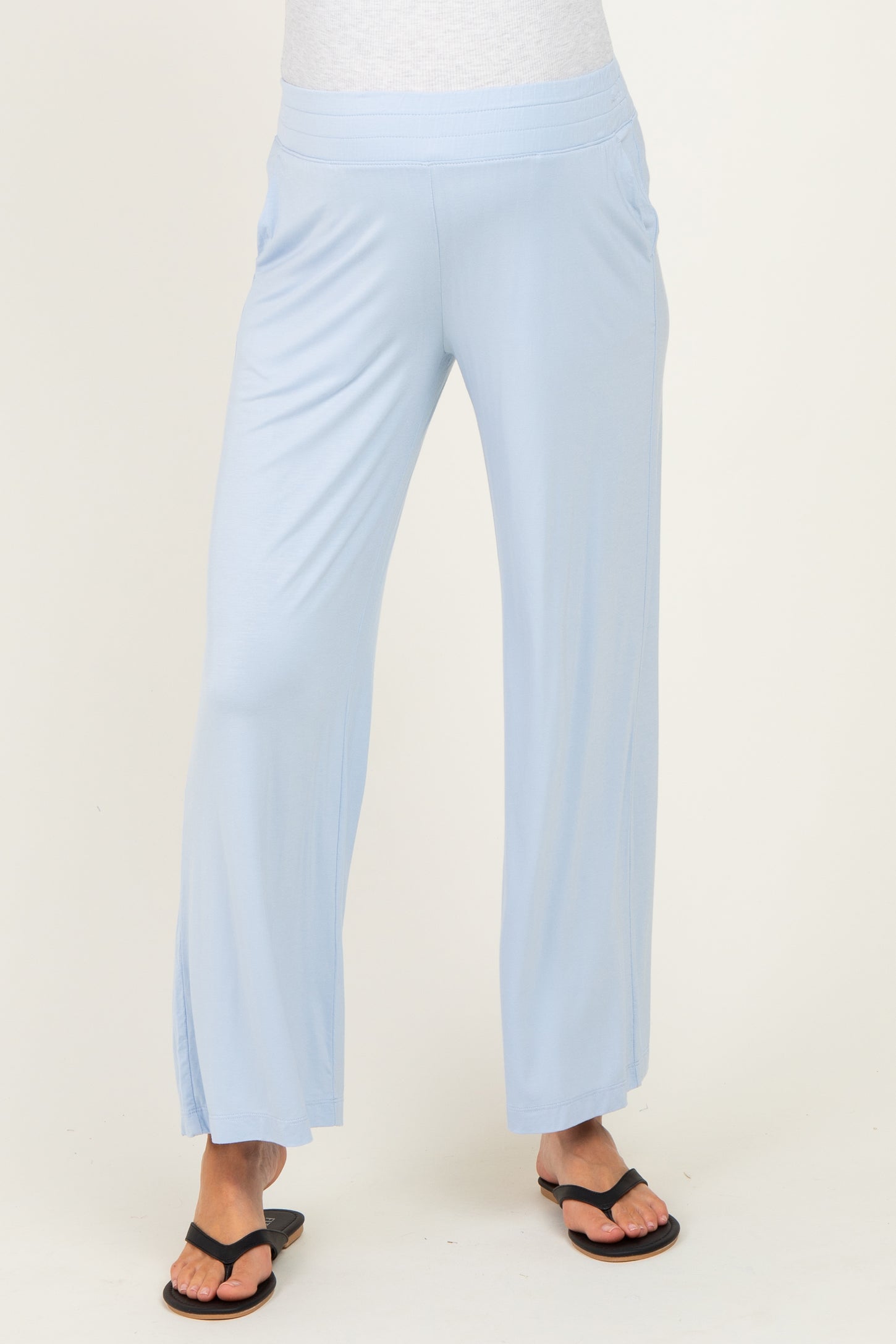 woman wearing light blue maternity wide-leg pants with side slits and a comfortable waistband