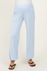 woman wearing light blue maternity wide-leg pants with side slits and a comfortable waistband
