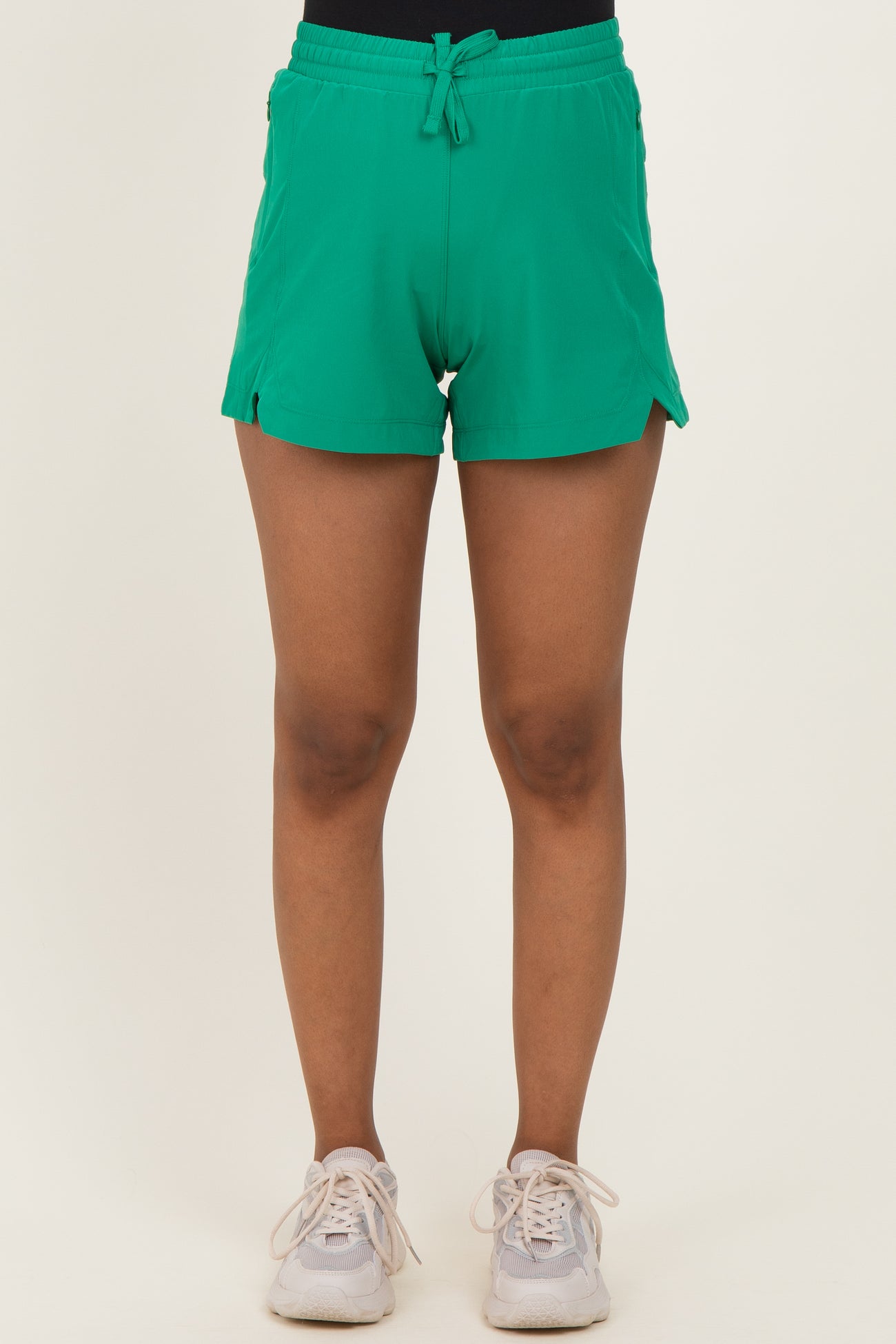 woman wearing green maternity shorts with side slits and drawstring waist