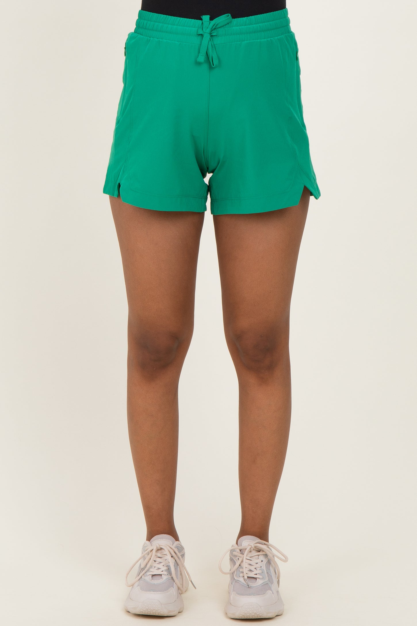 woman wearing green maternity shorts with side slits and drawstring waist